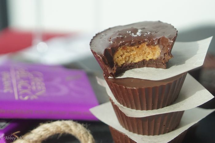 stack of vegan tahini caramel chocolate cups topped with flaky salt