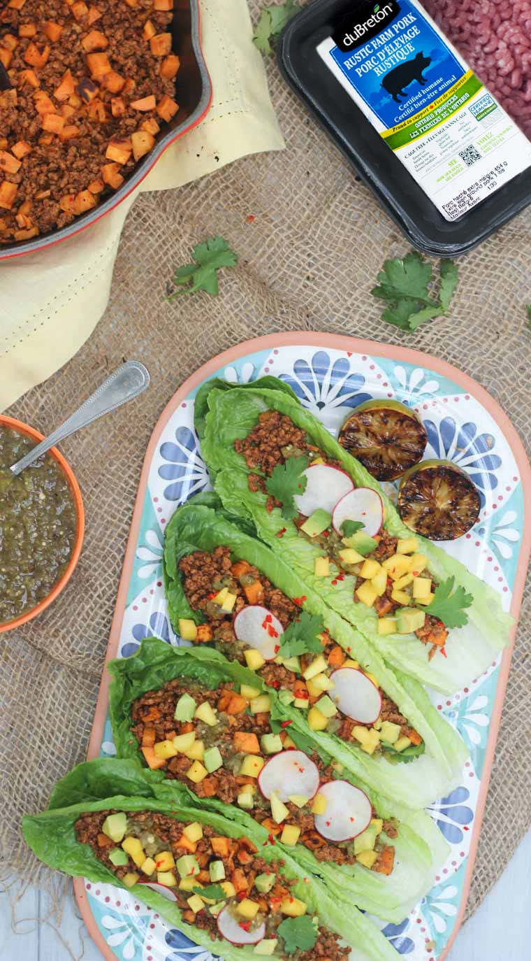 birds eye view of sweet potato and chorizo tacos served in lettuce wraps on a floral plate