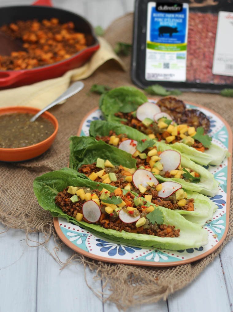 lineup of homemade sweet potato and chorizo tacos served in low carb lettuce wraps on a floral plate