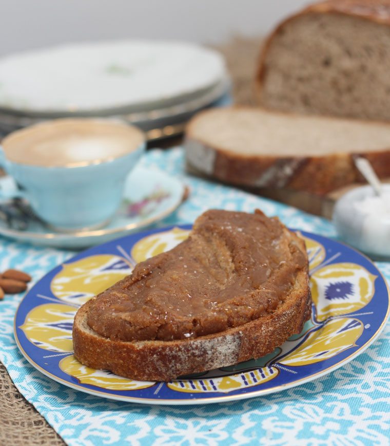 A piece of toast with salted caramel almond butter spread on top.