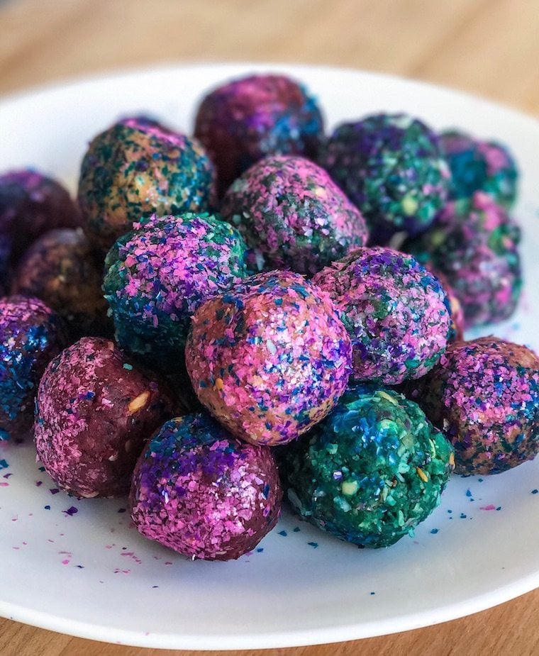 Energy balls coated in rainbow coloured sprinkles.