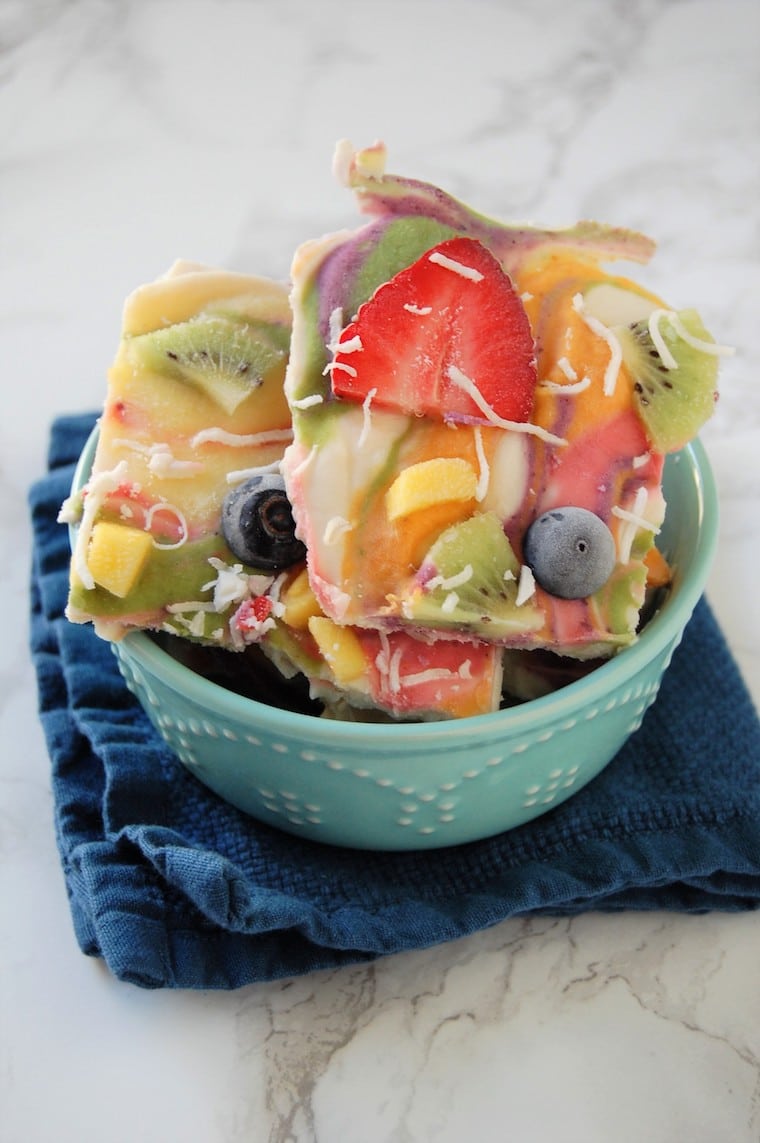 A green bowl with pastel coloured yogurt bark.
