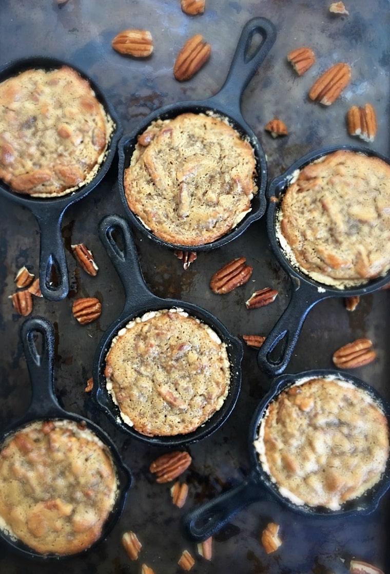 Birds eye view of mini pecan tarts garnished with fresh pecans.