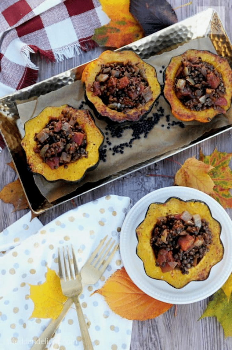 Birds eye view of multiple squashes stuffed with lentil filling for thanksgiving.