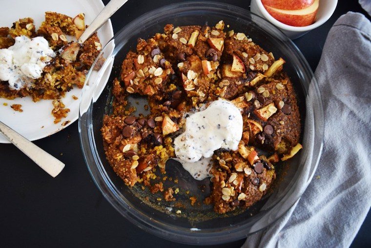 birds eye view of Dessert crumble in glass dish topped with ice cream.