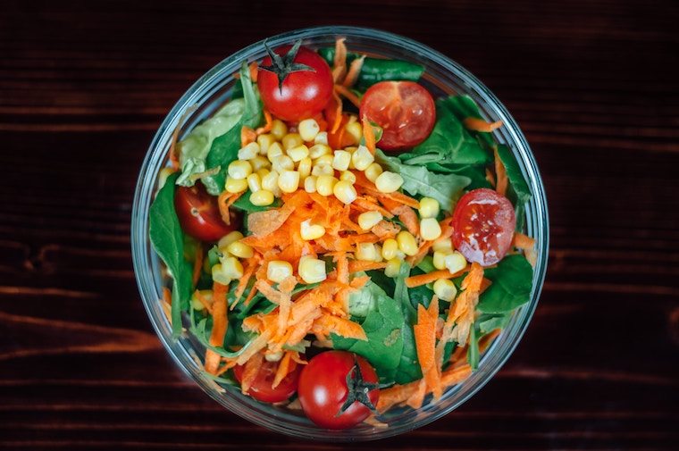 A meal prep container with a salad.