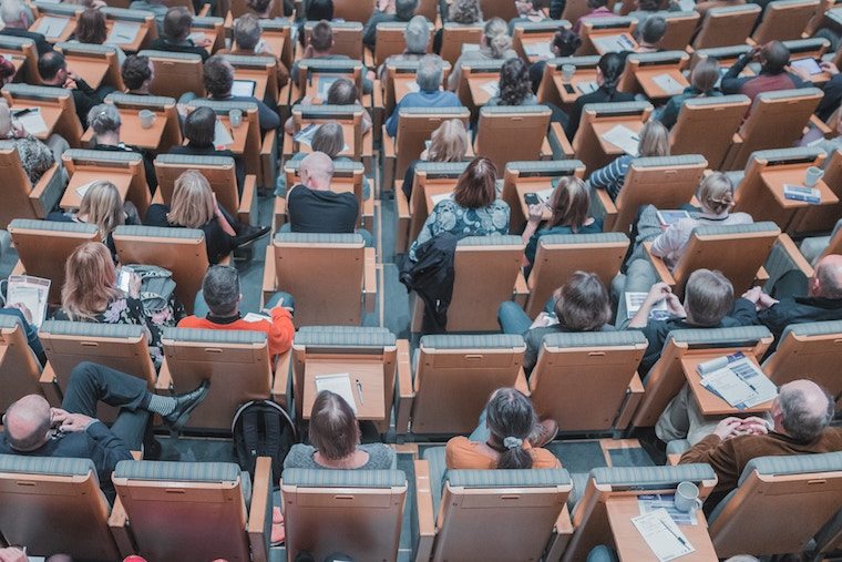 Inside of a lecture hall with students in the seats.