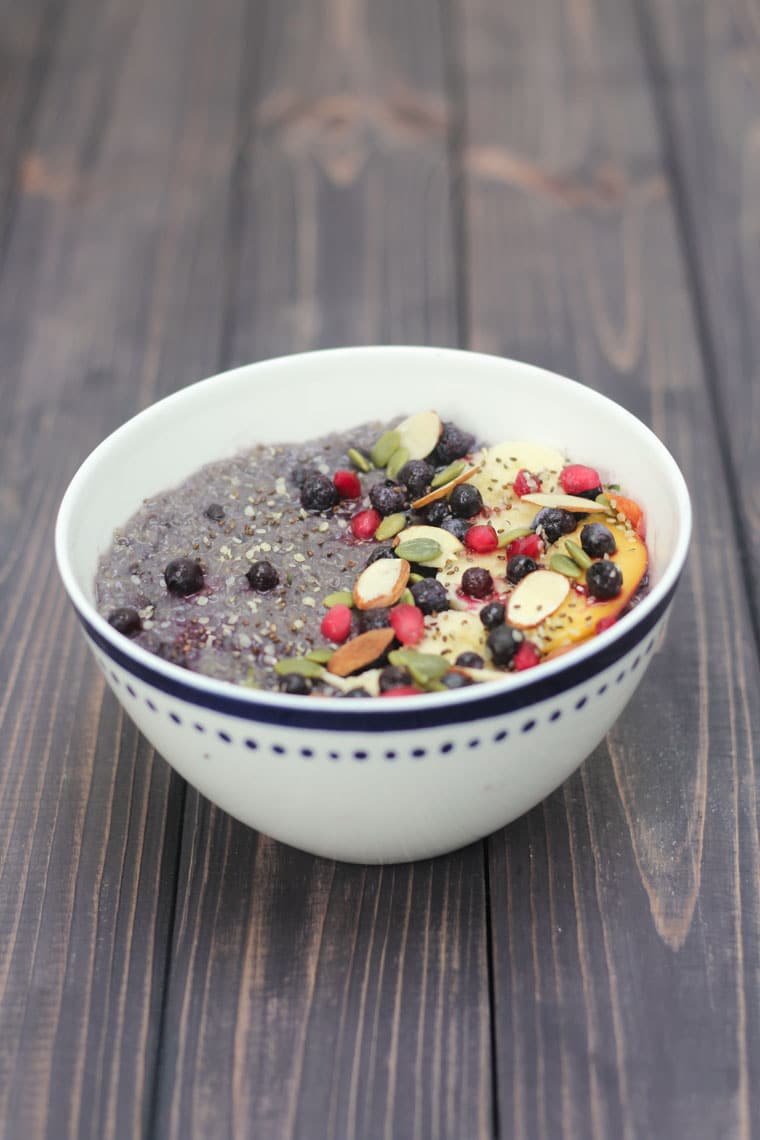 A white bowl of slow cooker blueberry quinoa.