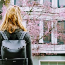 A woman standing in front of a building.