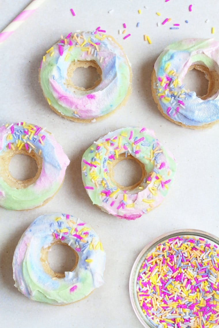 Five unicorn glazed donuts with sprinkles.