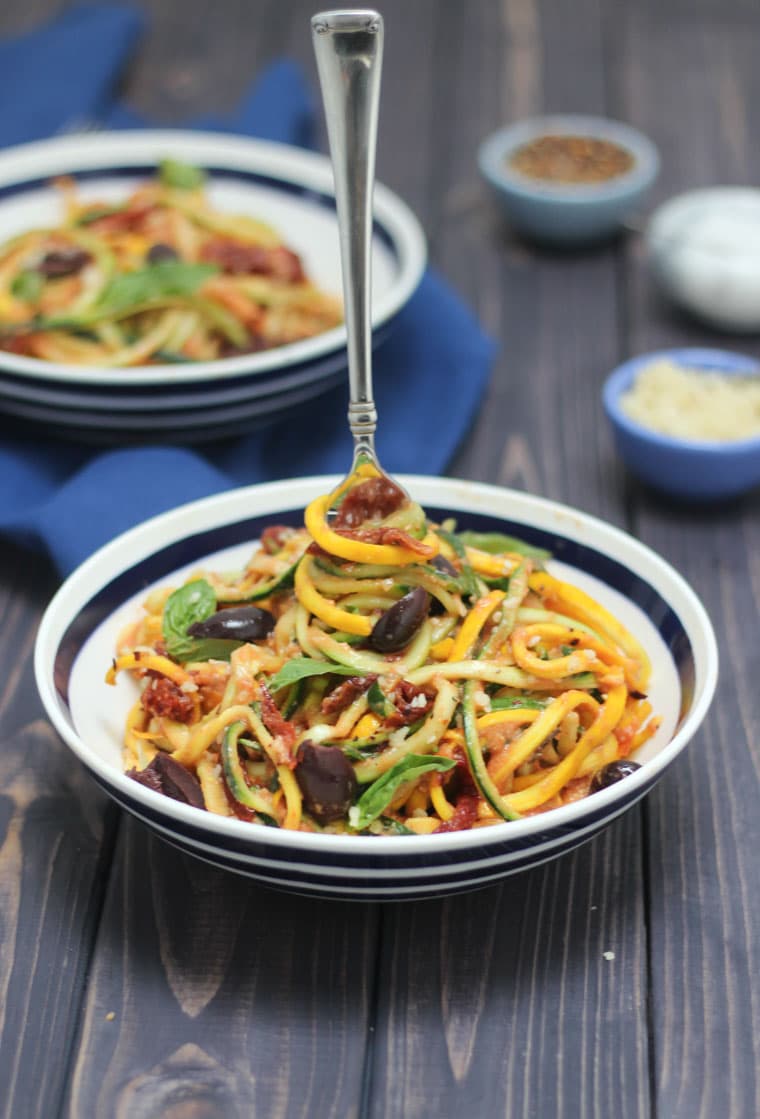 silver fork inside a bowl of low carb vegan vodka sauce and zucchini noodles