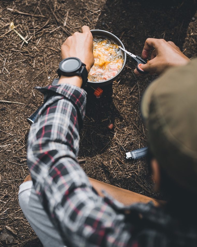 Man cooking outdoors.