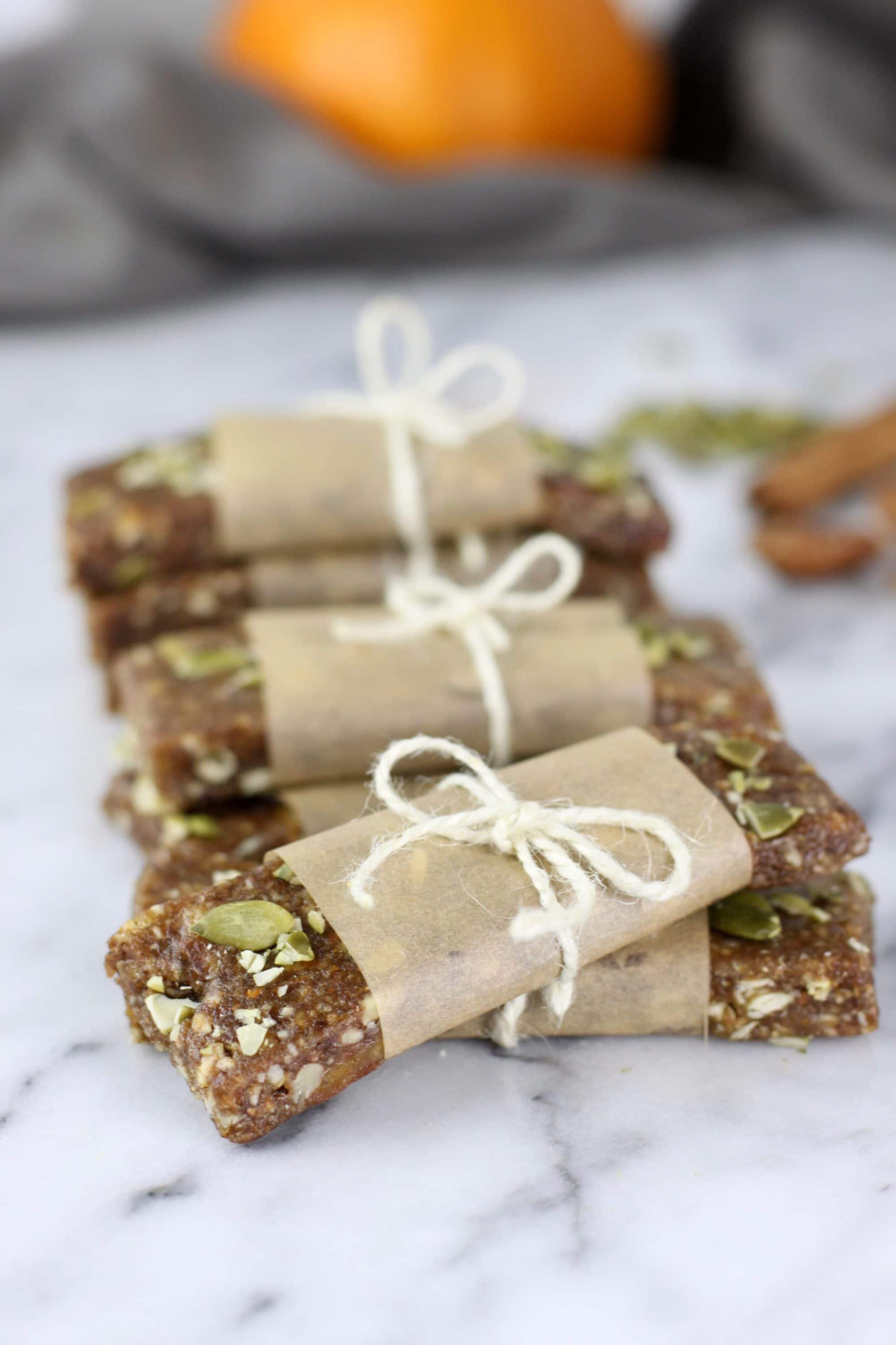 stack of paleo pumpkin spice protein bars wrapped in bows with white string