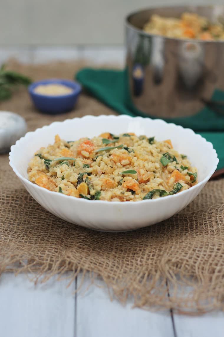 Squash risotto served in a large white bowl.