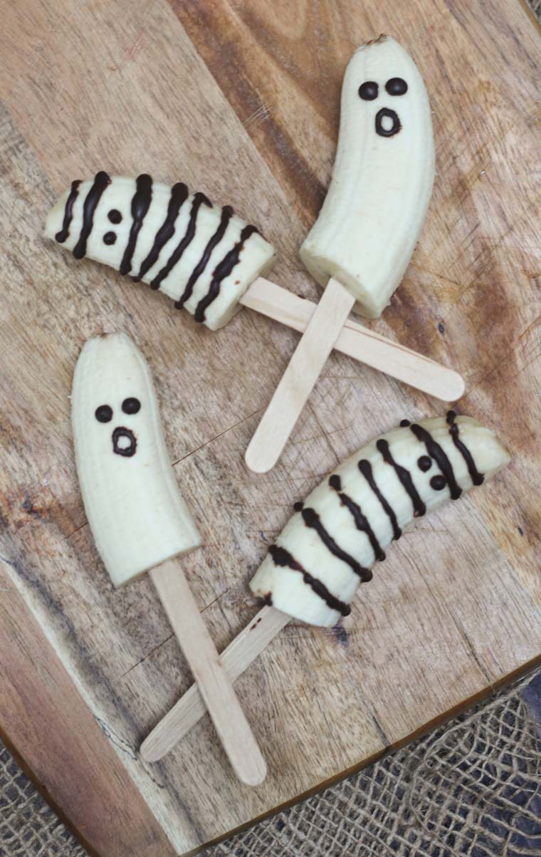 birds eye view of halloween banana ghosts on a wooden surface