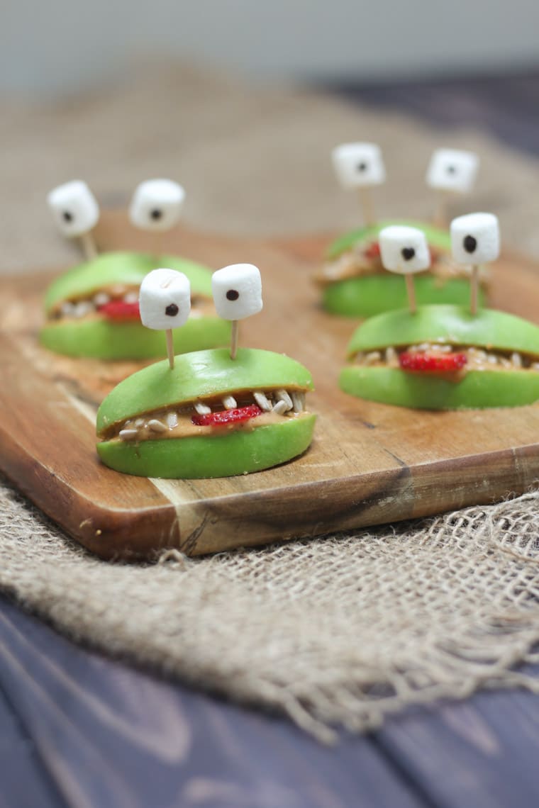 Close up of almond butter alien apples as healthy halloween snacks for kids.