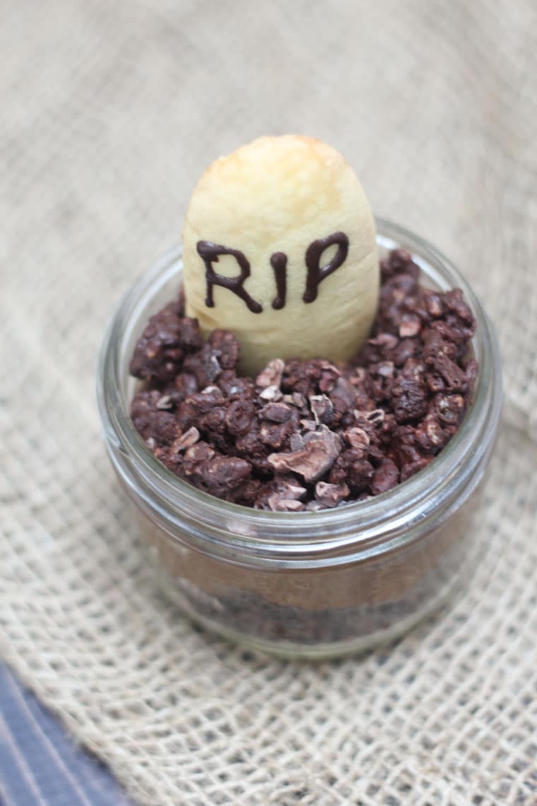 An overhead photo of a Halloween graveyard mousse with an edible gravestone saying RIP in chocolate.
