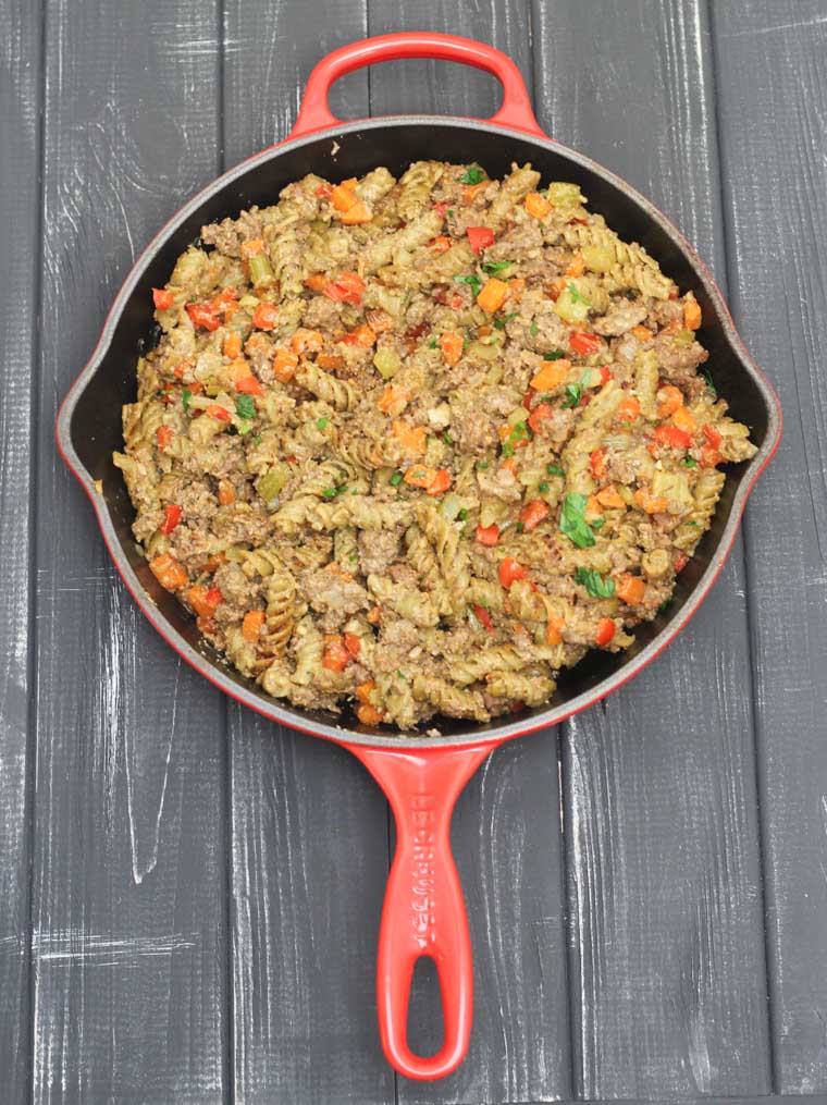 A red skillet containing a vegan version of hamburger helper.