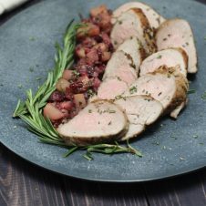 A high protein gluten free Paleo Rosemary Pork Tenderloin with Pear Cranberry Rosemary Sauce that's easy enough for a weeknight but elegant enough for hosting company!