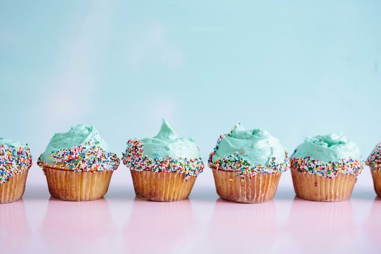 Blue frosted cupcakes lined up.
