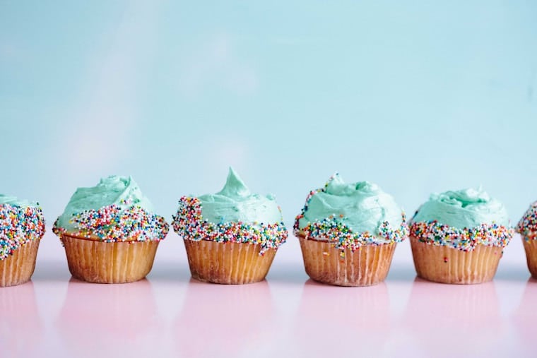 Blue frosted cupcakes lined up. 