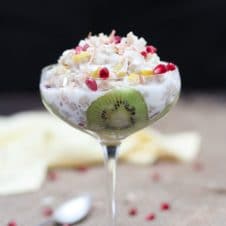 A glass with mango kiwi vegan coconut rice pudding.