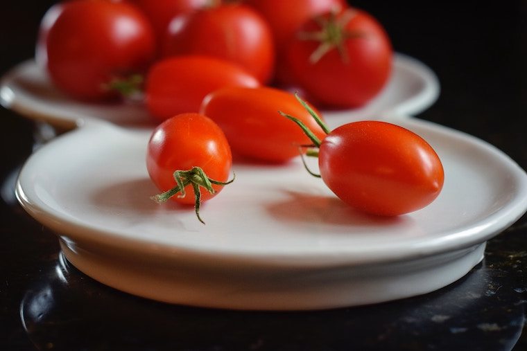 Close up of cherry tomatoes on a plate.