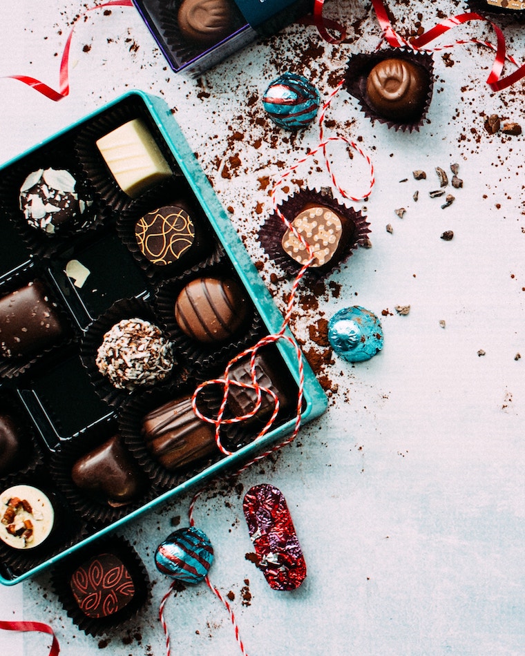 Box of chocolate and chocolates scattered. 