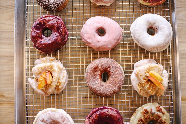 Birds eye view of various assortment of donuts.