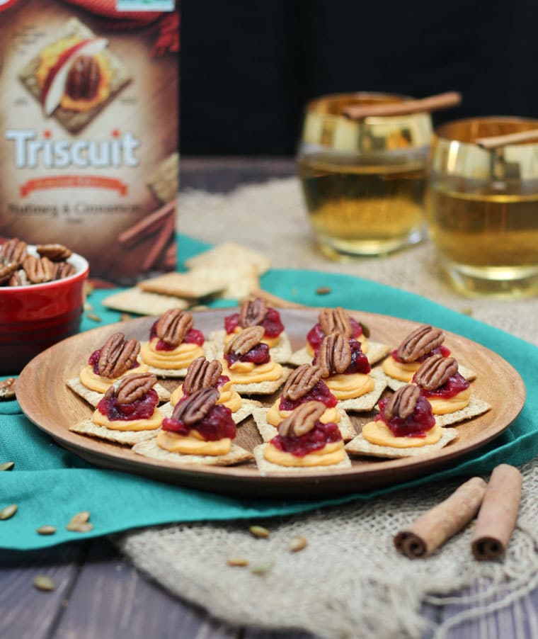 A plate of sweet potato and cranberry mousse bites on a table with a triscuit box in the background.