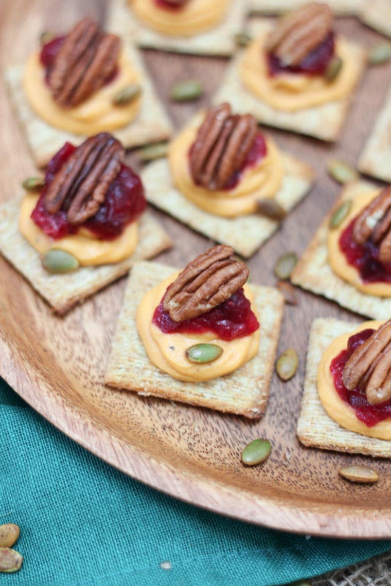 A close up of a plate with sweet potato with cranberry mousse bites.