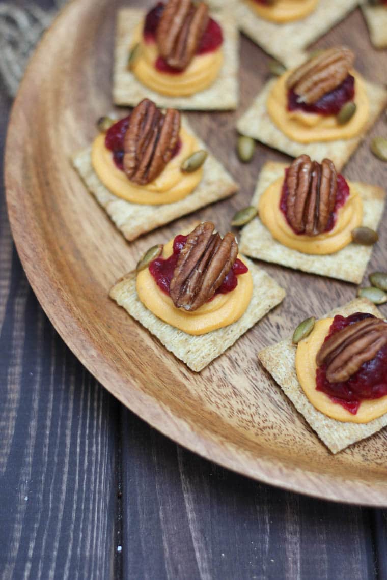 A close up of plate of sweet potato and cranberry mousse bites.