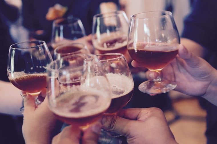 People holding glasses of alcohol. 