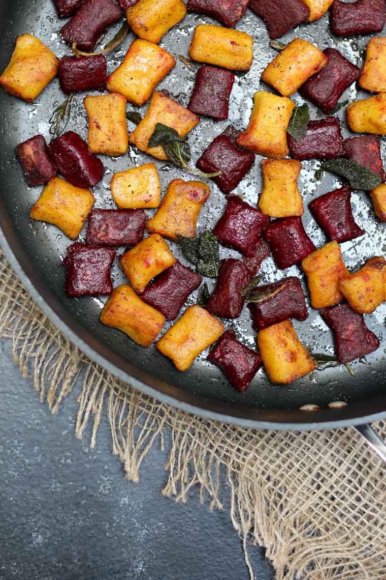Colourful gluten free beet gnocchi in a pan.