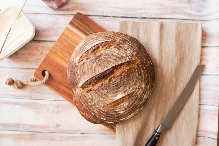 Loaf of bread on cutting board.