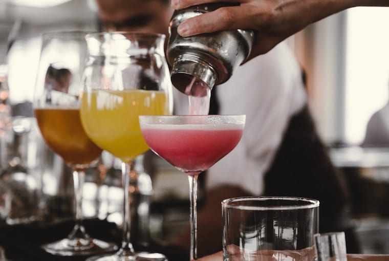 Bar tenders making various cocktails