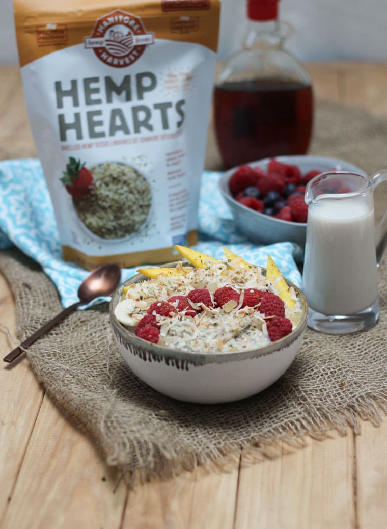 A bowl of no oats porridge with a bag of hemp hearts in the back.