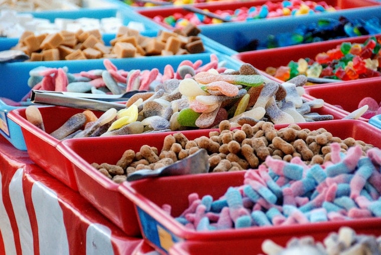 A variety of gummy candies in individual serving bins. 