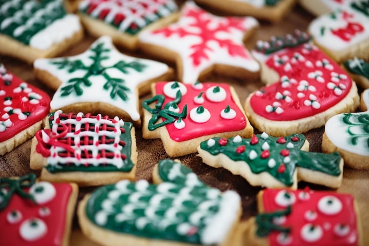 Several colourful holiday cookies laying on a counter which may cause stomach cramps. 