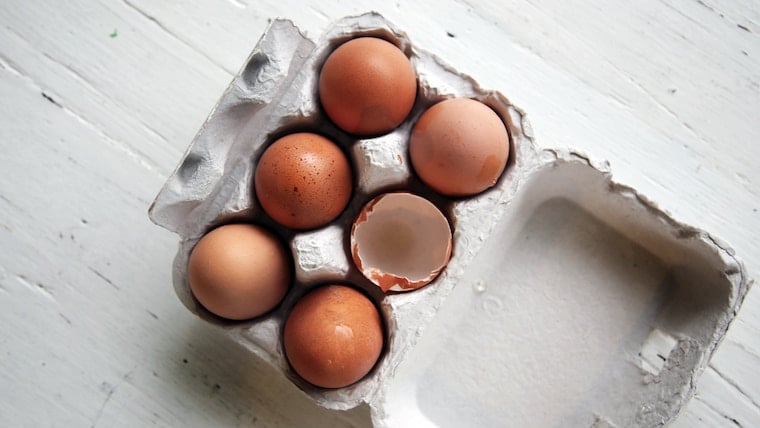 Close up of 6 eggs in a carton.