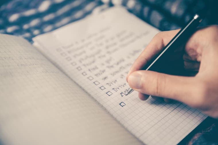 person writing in a journal