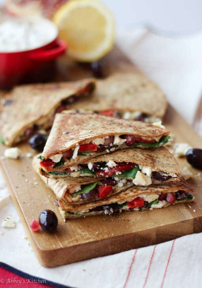 stack of vegetarian hummus quesadillas on a wooden serving board
