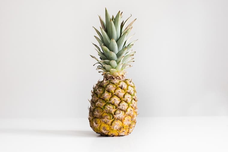 whole pineapple on a white table