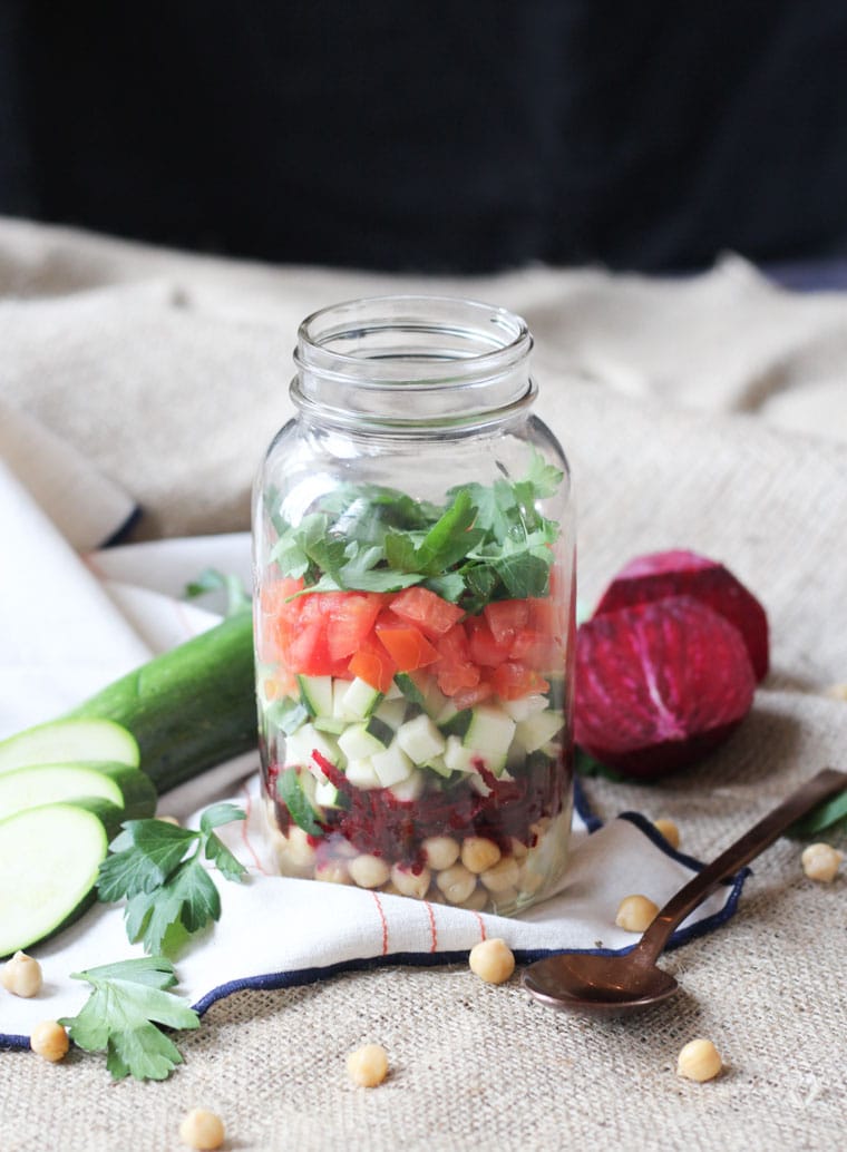 vegan chickpea and beet mason jar soup garnished with cucumbers and beets