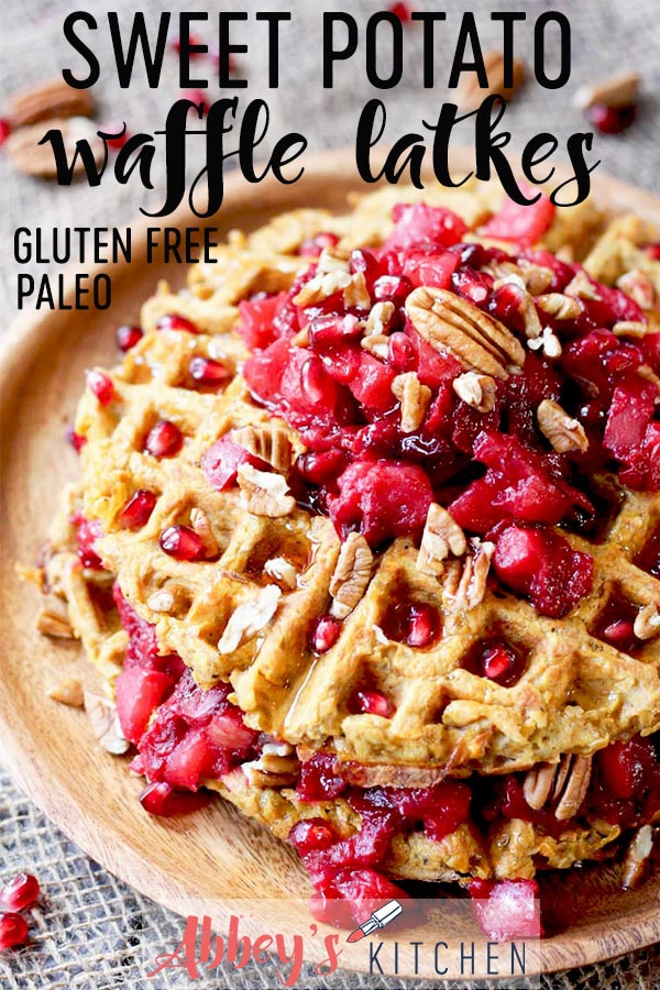 pinterest image of sweet potato waffle latkes topped with cranberry compote and nuts on a wooden plate with text overlay