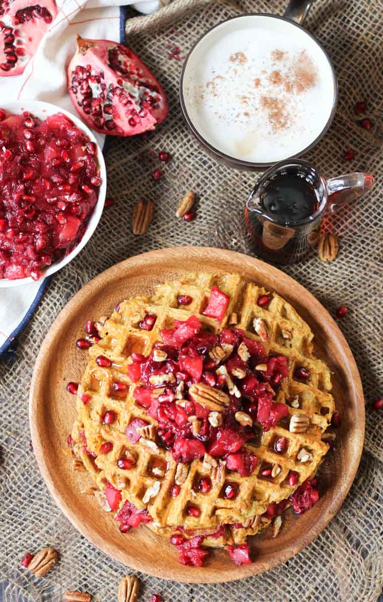 Large waffle served on wooden plate. 
