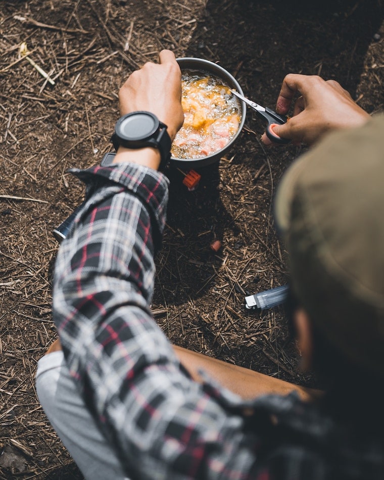 A person cooking outside.