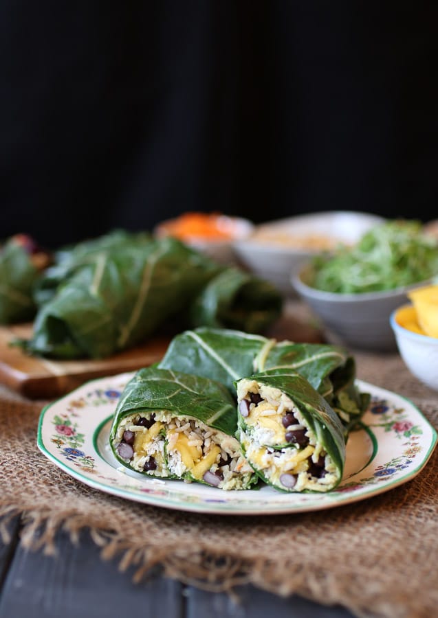 image of vegan black bean and avocado collard green wrap on a white plate
