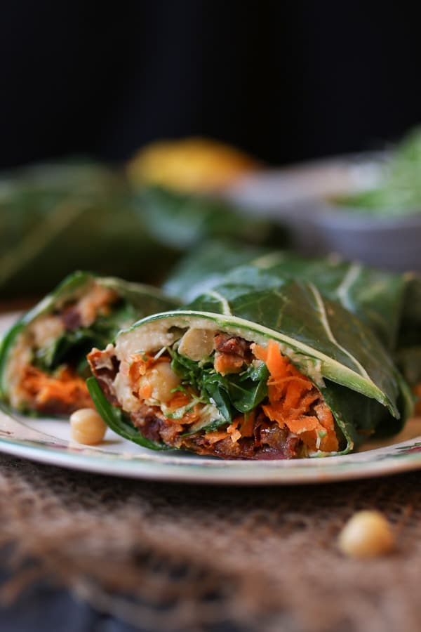 close up image of mediterranean collard green wrap on a white plate