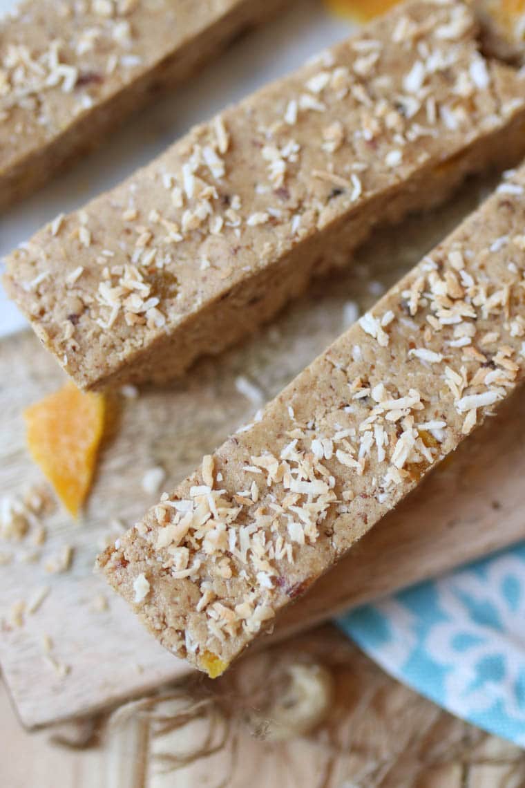 Close up of protein bars topped with dried mango and shredded coconut. 